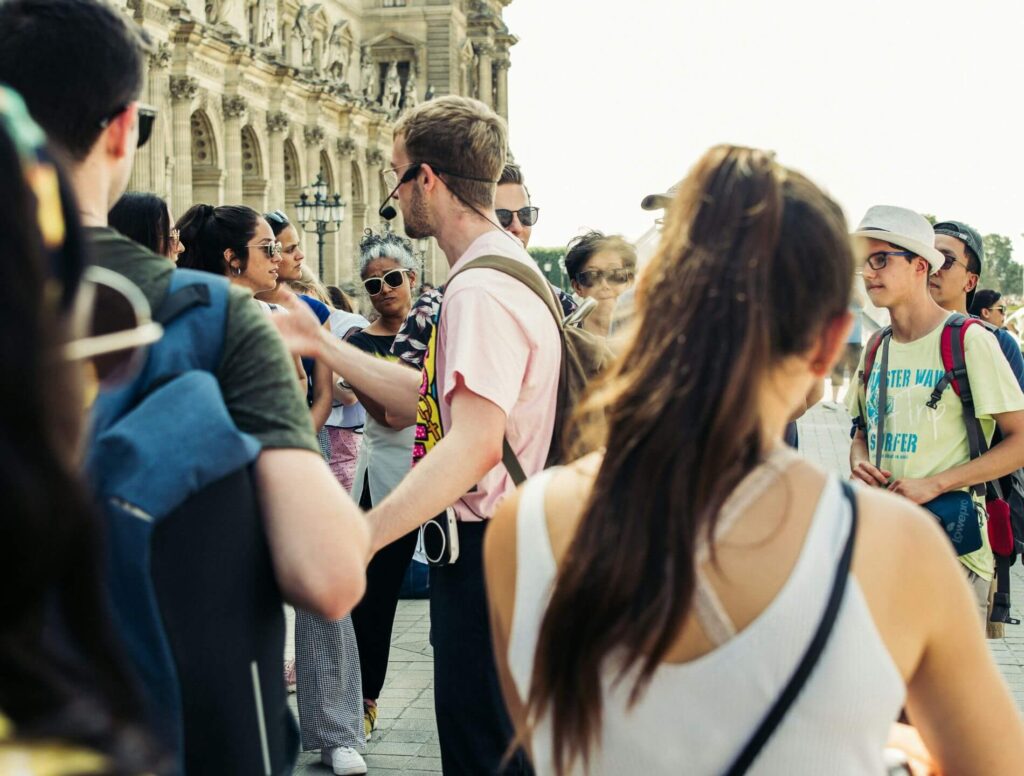 group of people listening to a tour guide
