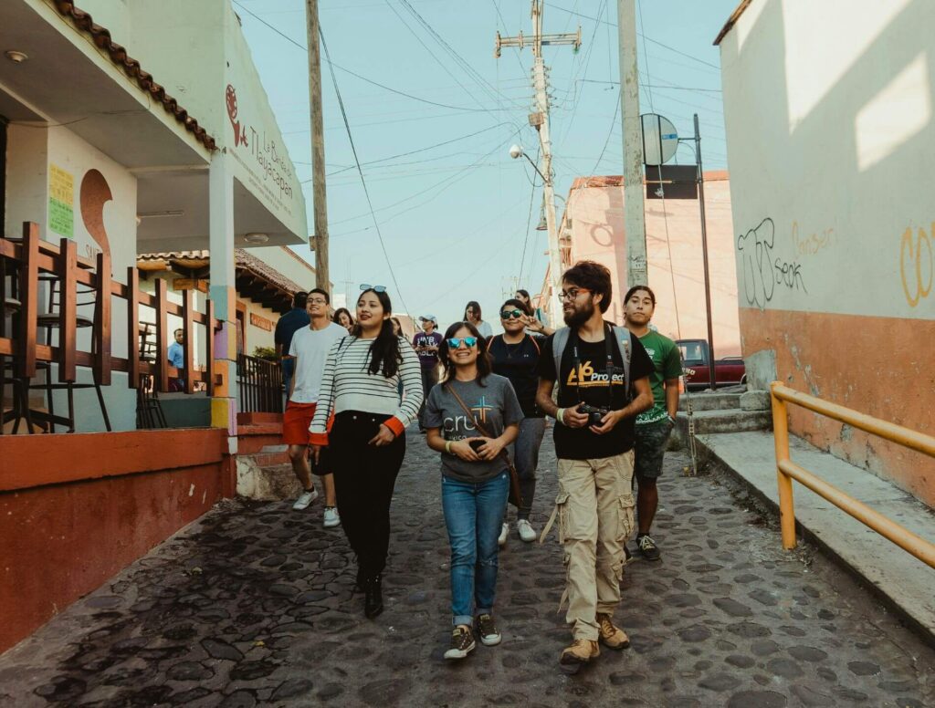 group of young adults walking down a street