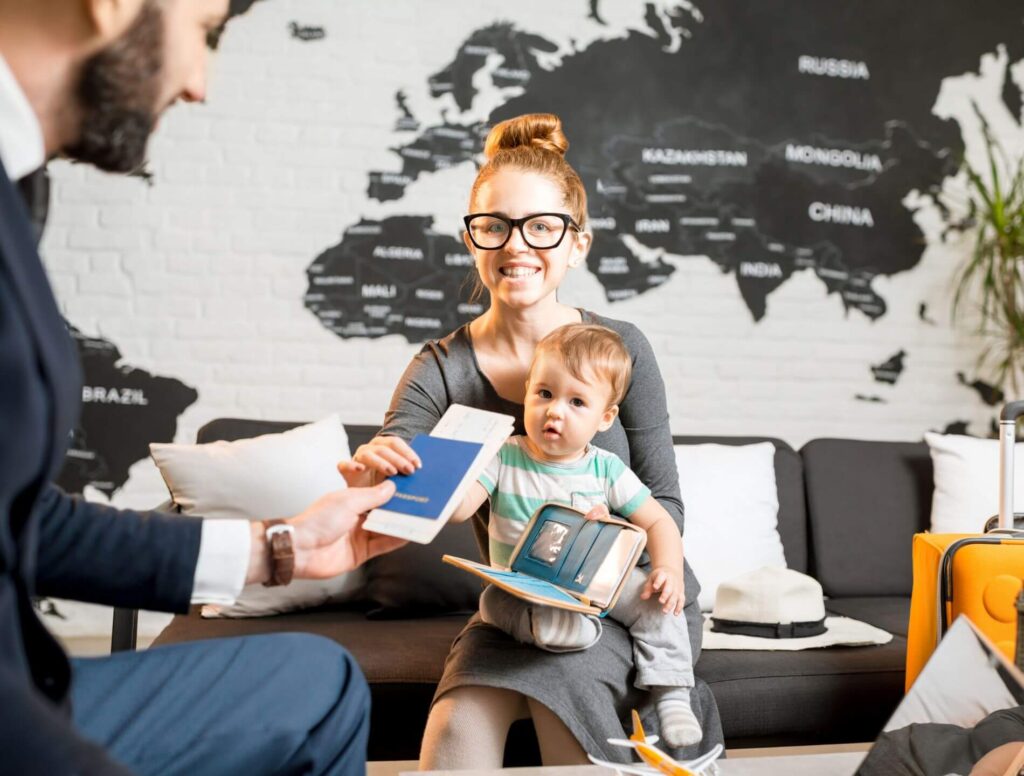 Woman with child on her lap and travel documents in her hand