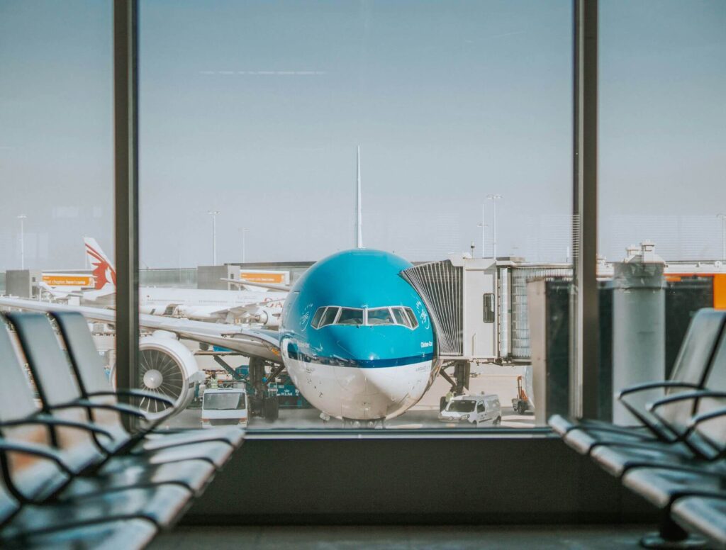 View of airplane from inside airport terminal