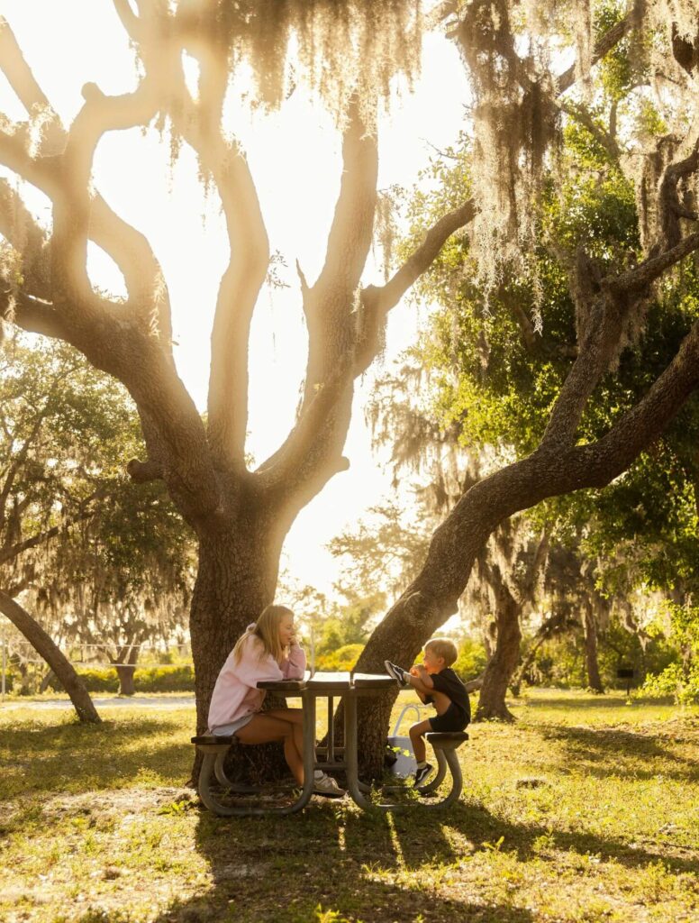 Mother and son sitting at a park bench