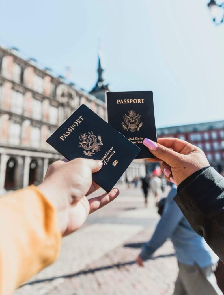 two hands holding passports
