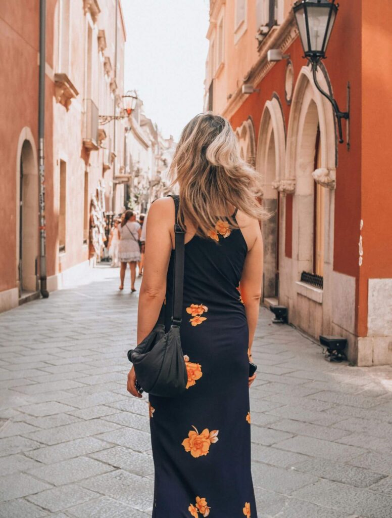 Woman walking through narrow street
