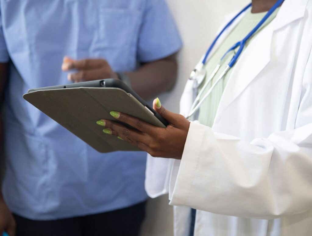Doctor filling out information on an iPad