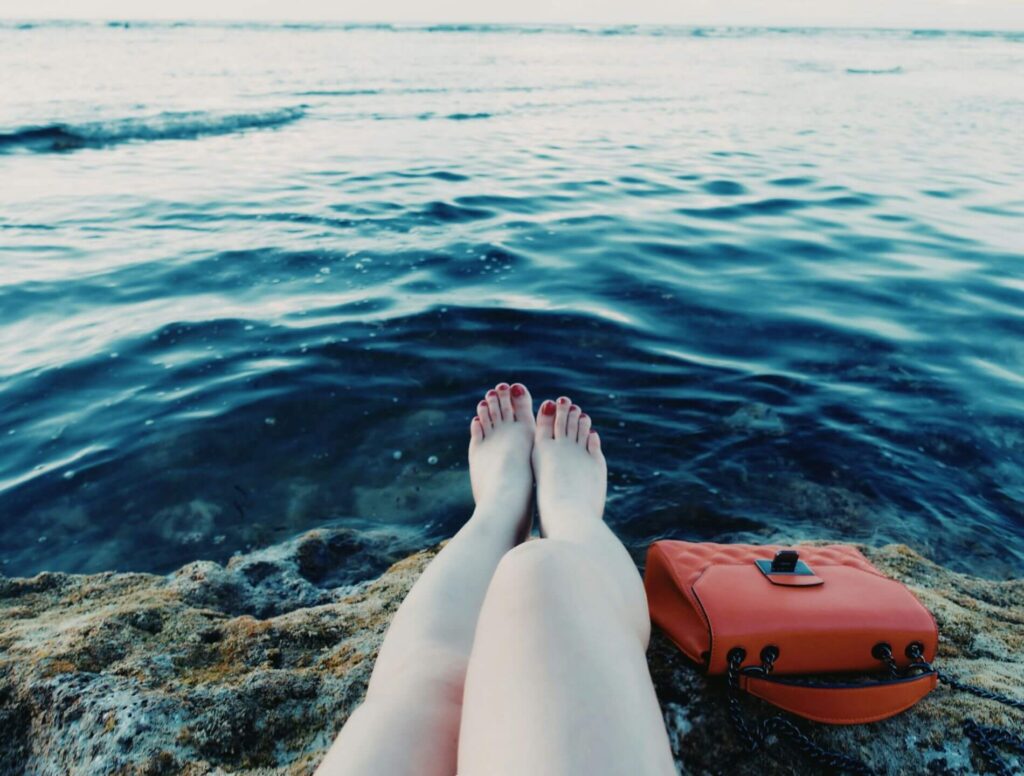 Woman sitting by the water