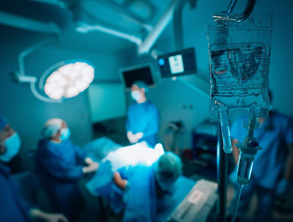 doctors surrounding a patient in an operating room