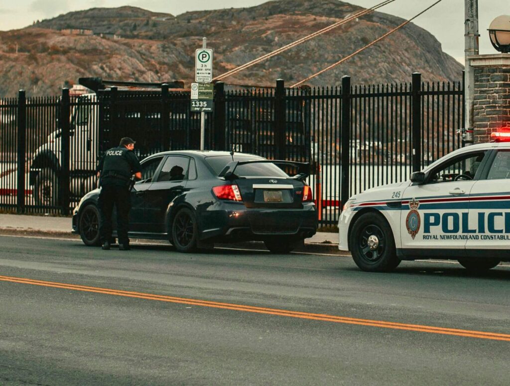 police officer pulling over a car on the side of the road