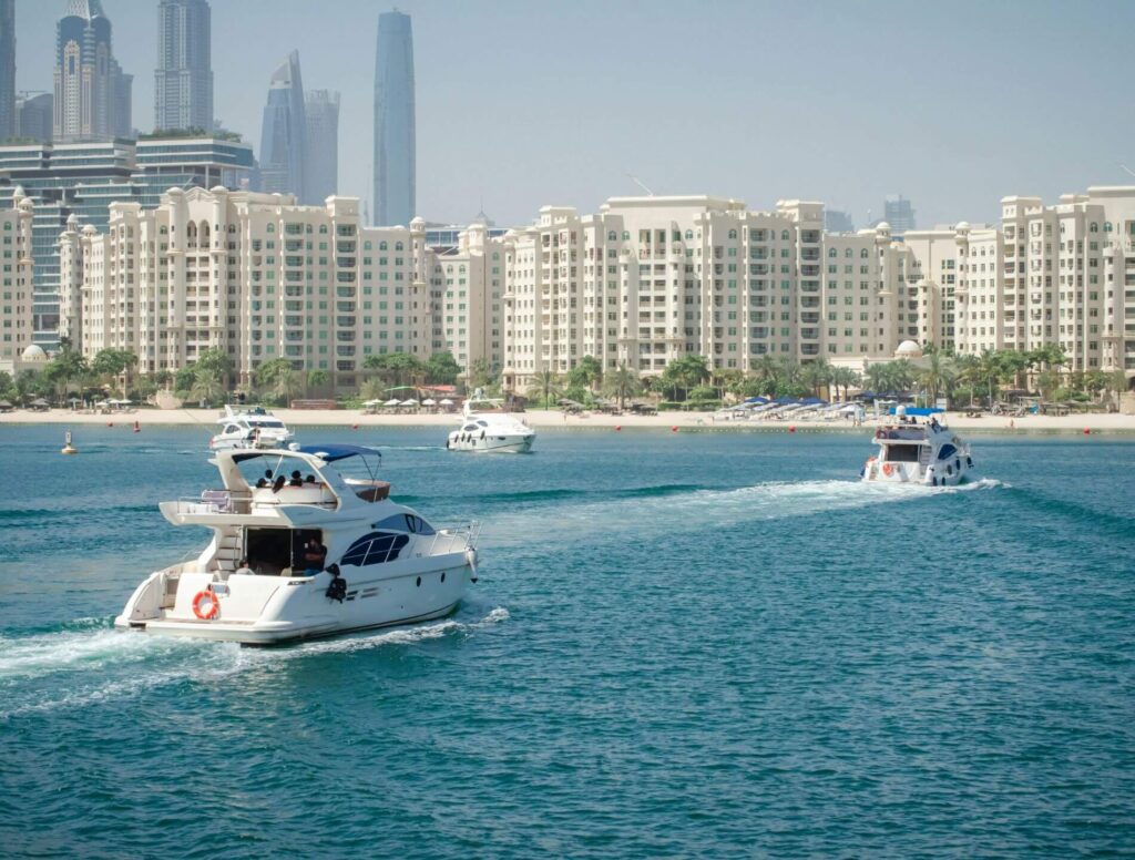 Yachts heading towards Dubai skyline