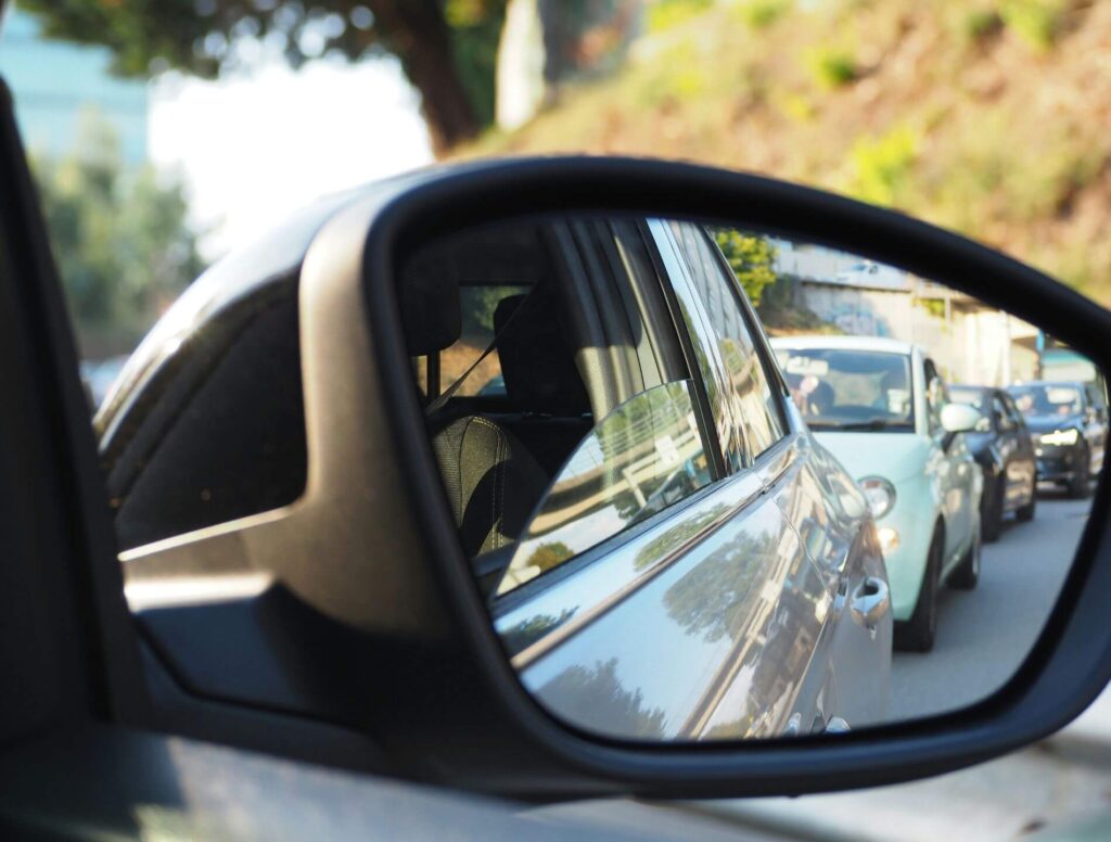 car side mirror showing line of cars behind
