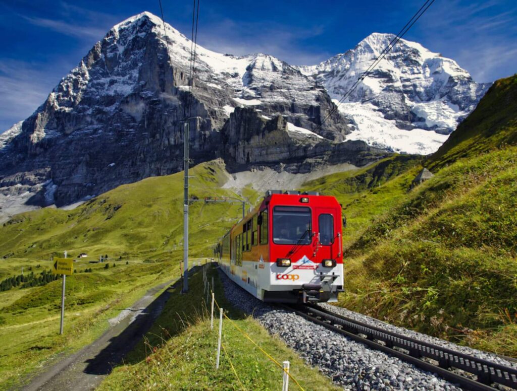 red train going into the Alps